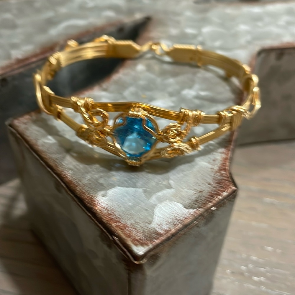 14kt artisan wire bracelet with one large blue topaz stone